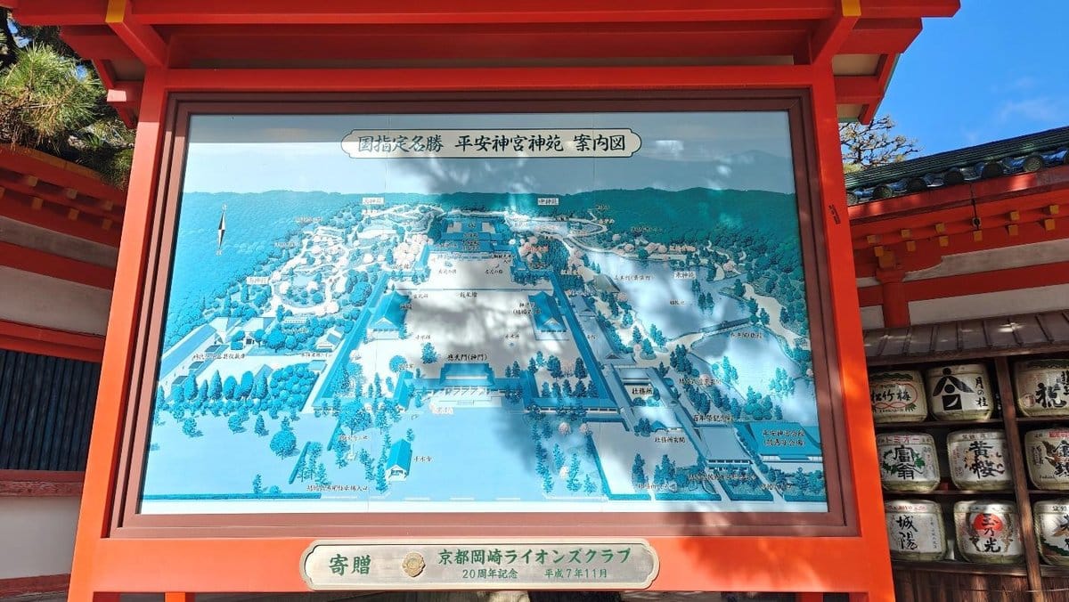 Colorful map display in wooden frame at a shrine entrance