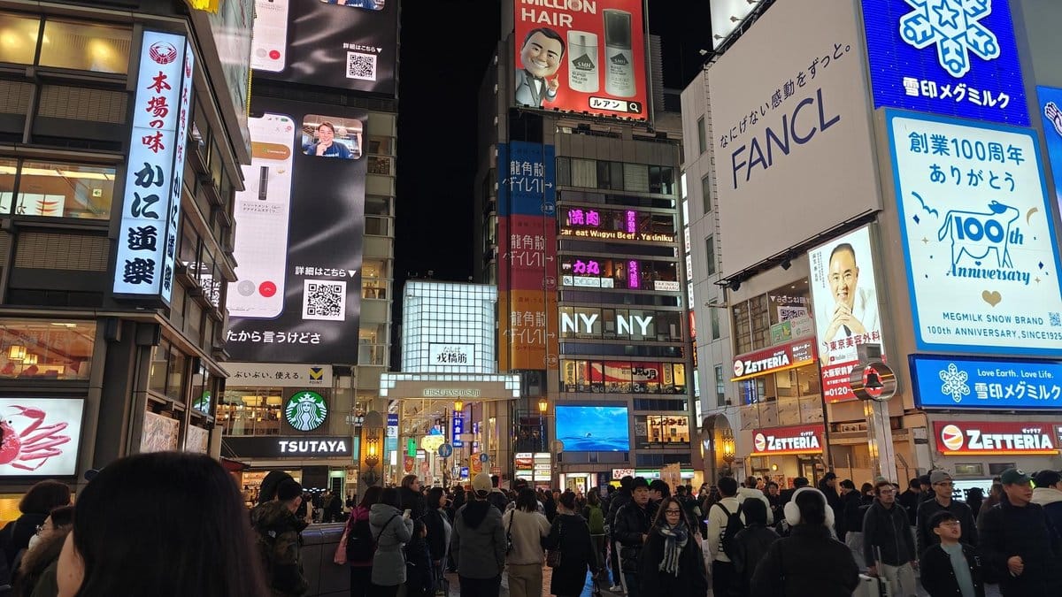 Crowded city street with bright billboards