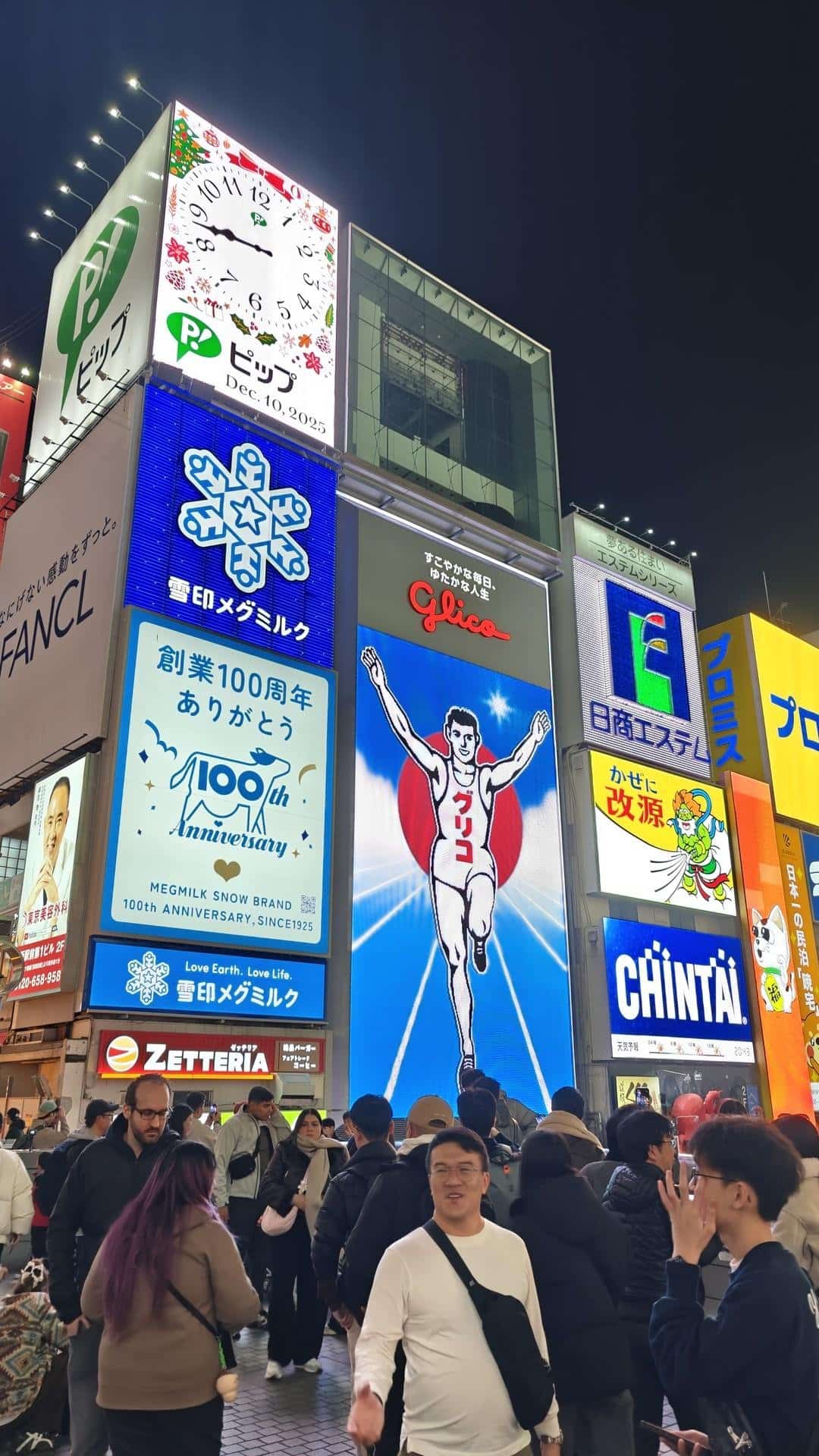 Crowded street with bright neon signs