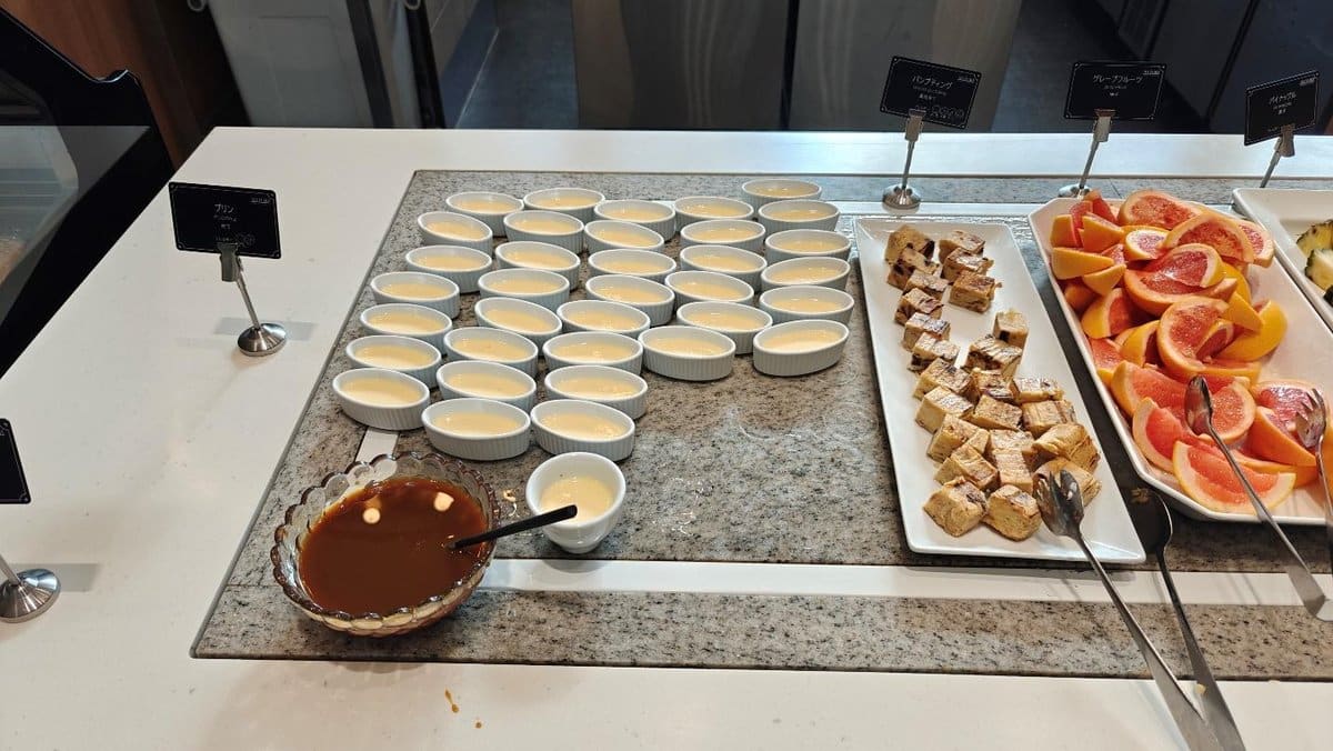 Dessert buffet with custards and fruits