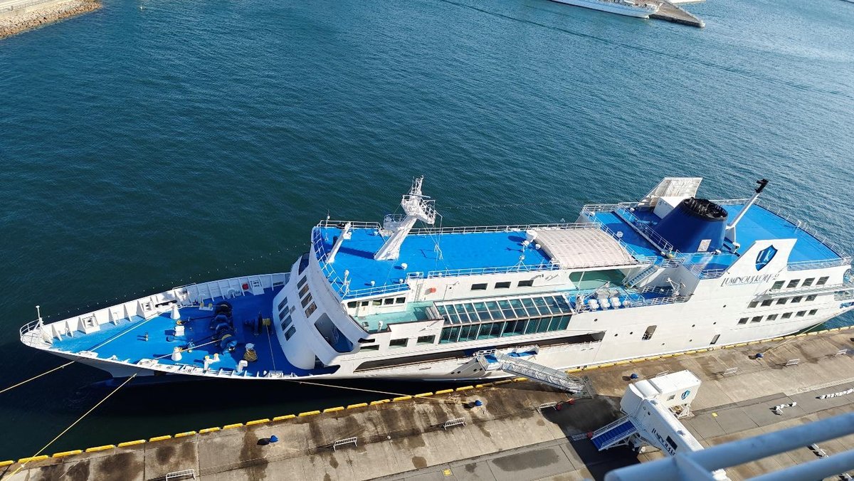 Docked cruise ship in sunny harbor
