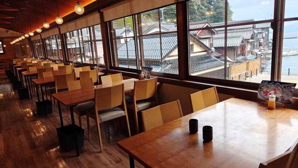 Empty cafe overlooking traditional rooftops