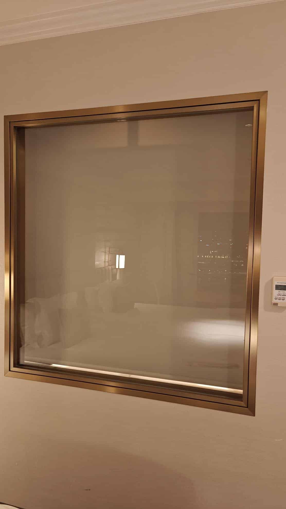 Frosted hotel room window reflection