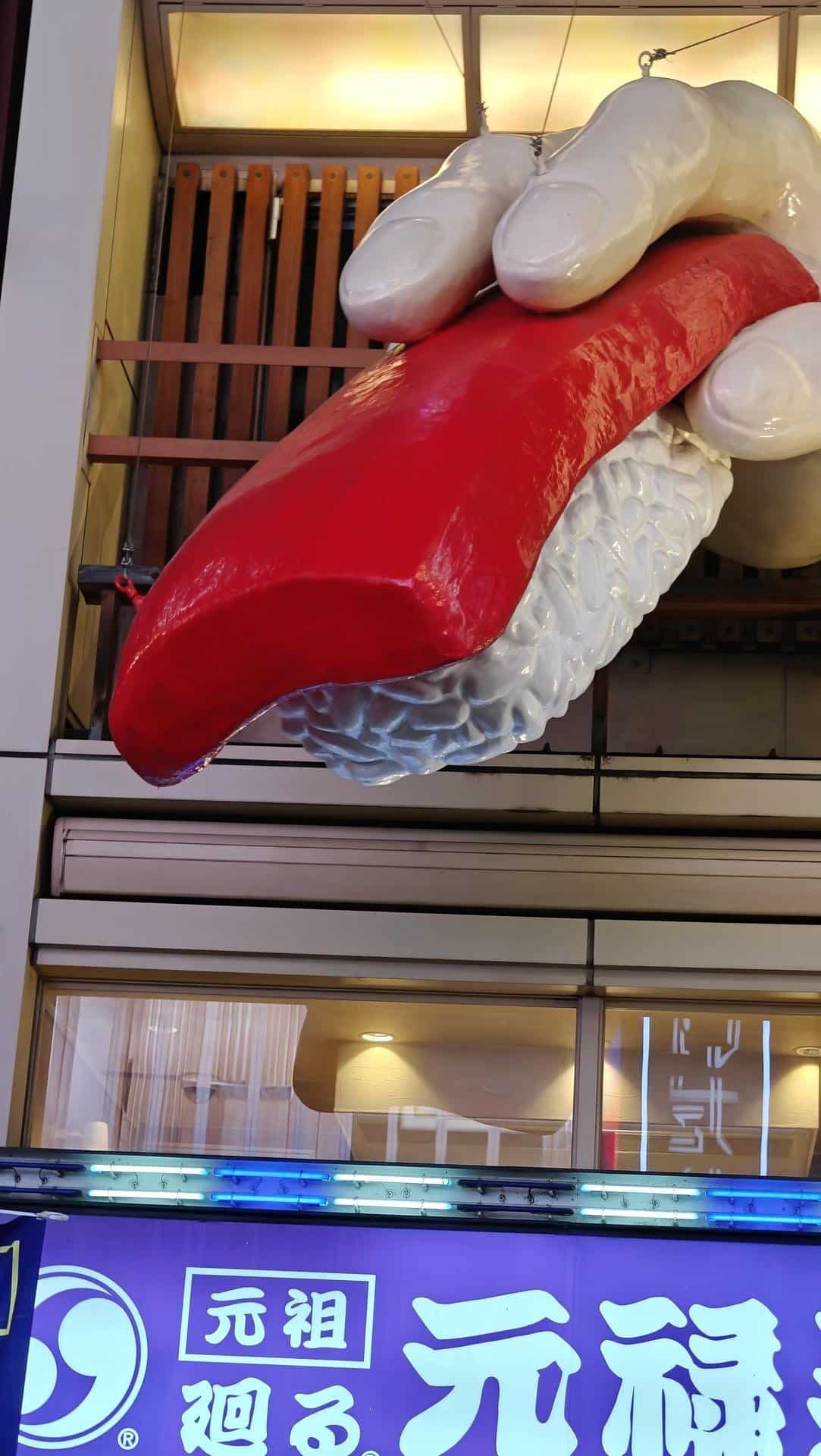 Giant sushi sculpture on building facade