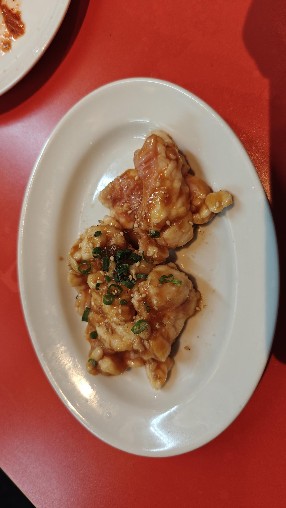 Glazed chicken pieces on white plate