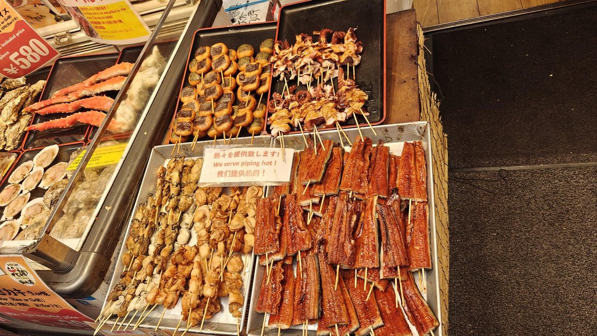 Grilled skewers at a food market stall