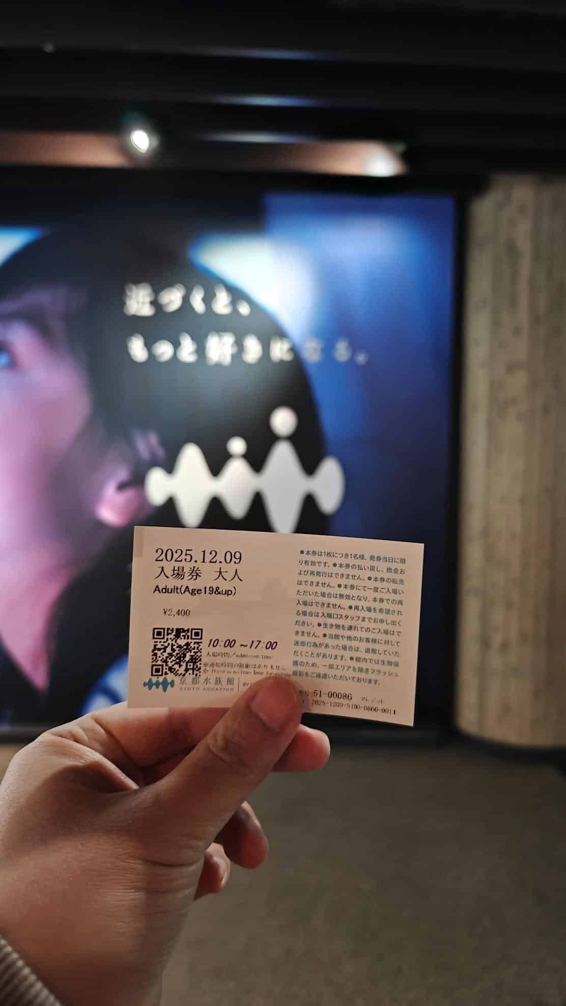 Hand holding a ticket with a blurred background