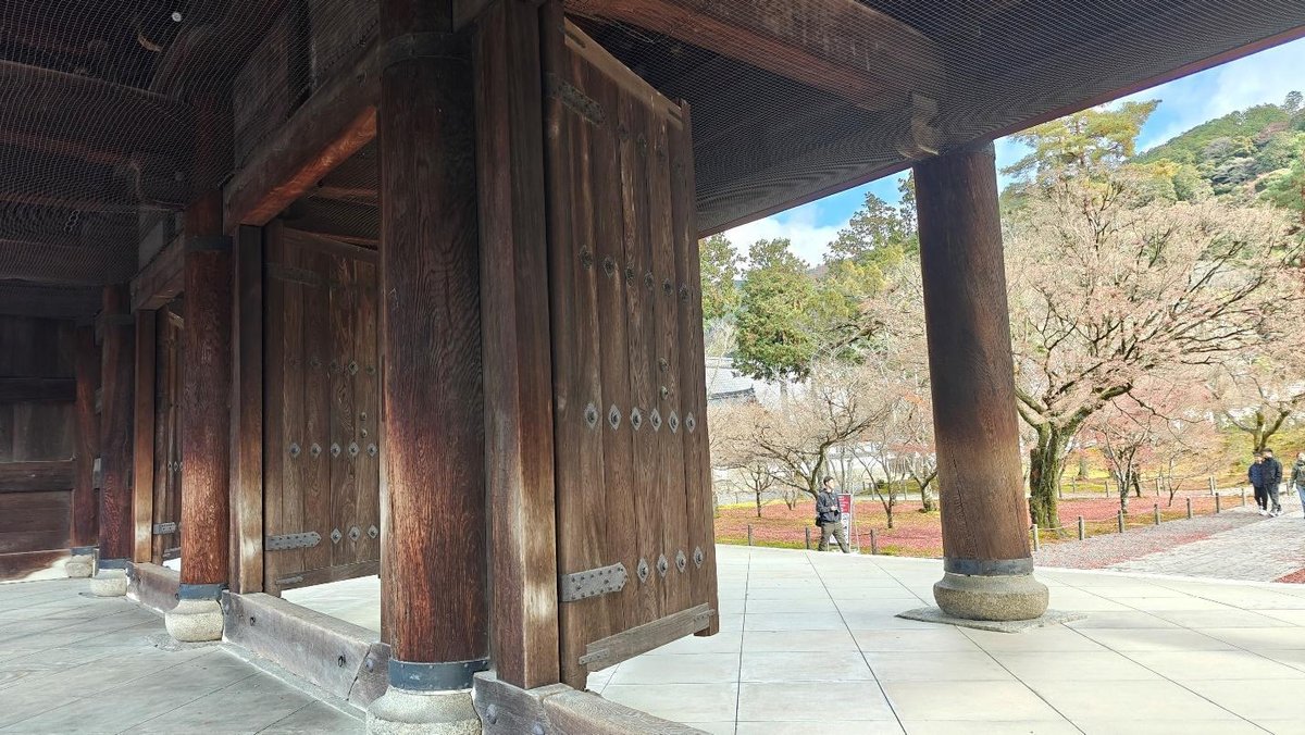 Historic wooden gate with pathway and trees