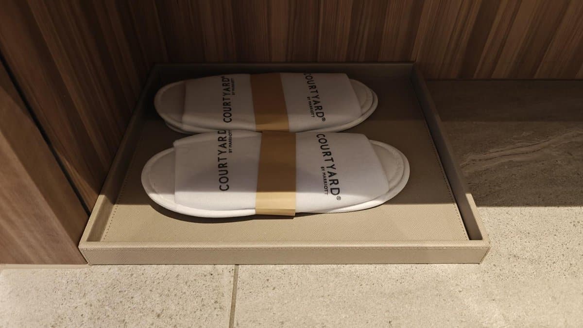 Hotel slippers on wooden shelf