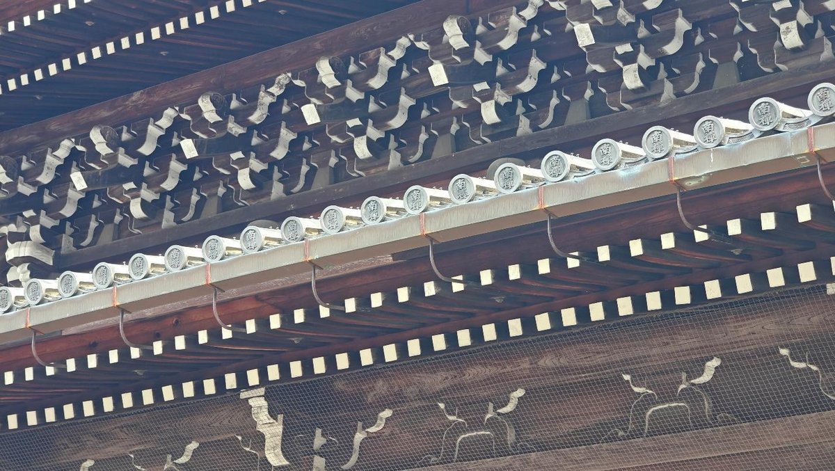 Intricate wooden carvings on traditional roof architecture