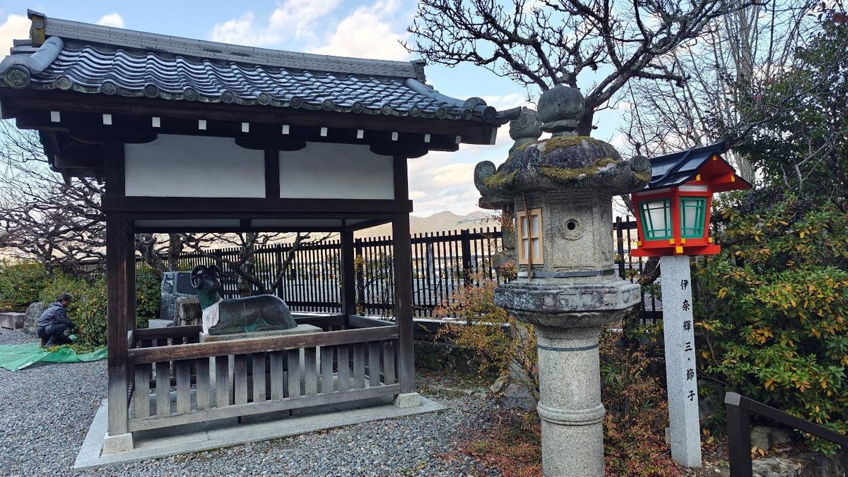 Japanese shrine with stone lantern and autumn foliage