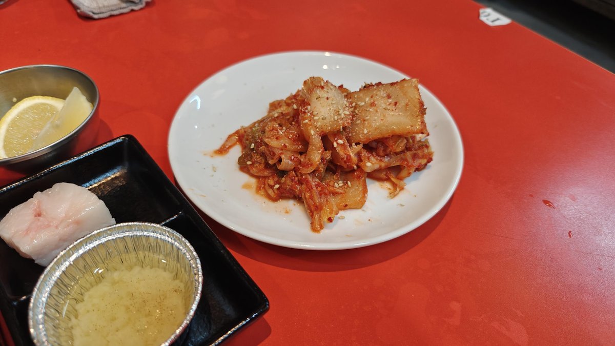 Kimchi on white plate with lemon slice