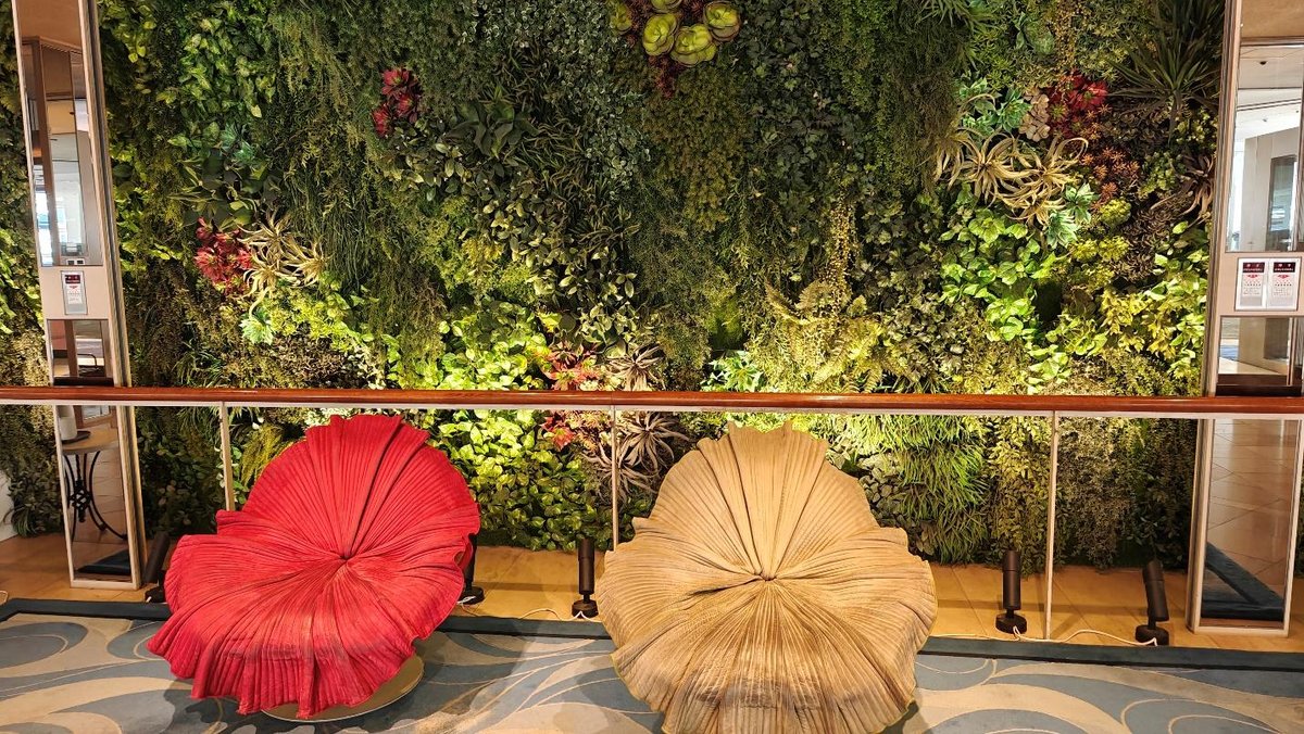 Leafy wall with artistic chairs