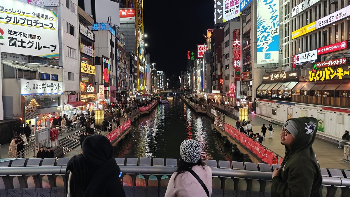 Lively city canal at night with people