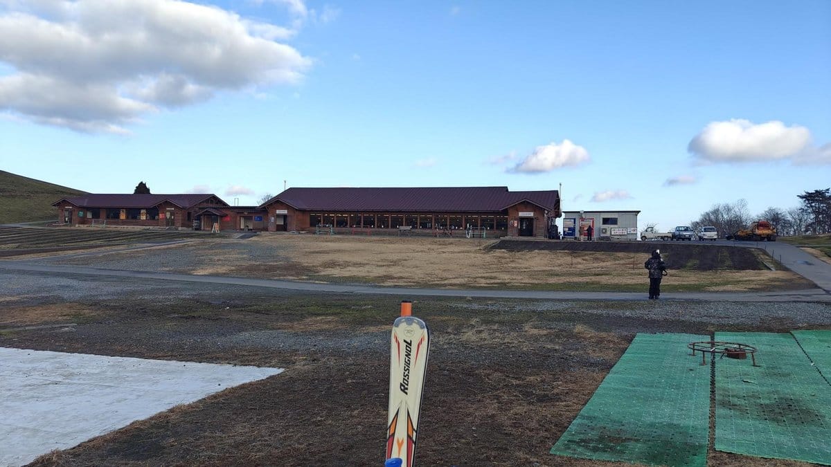 Lodge and field under blue sky
