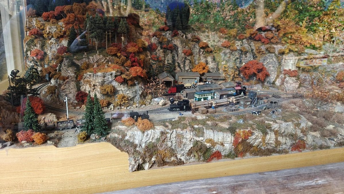 Miniature train landscape with autumn foliage and hills