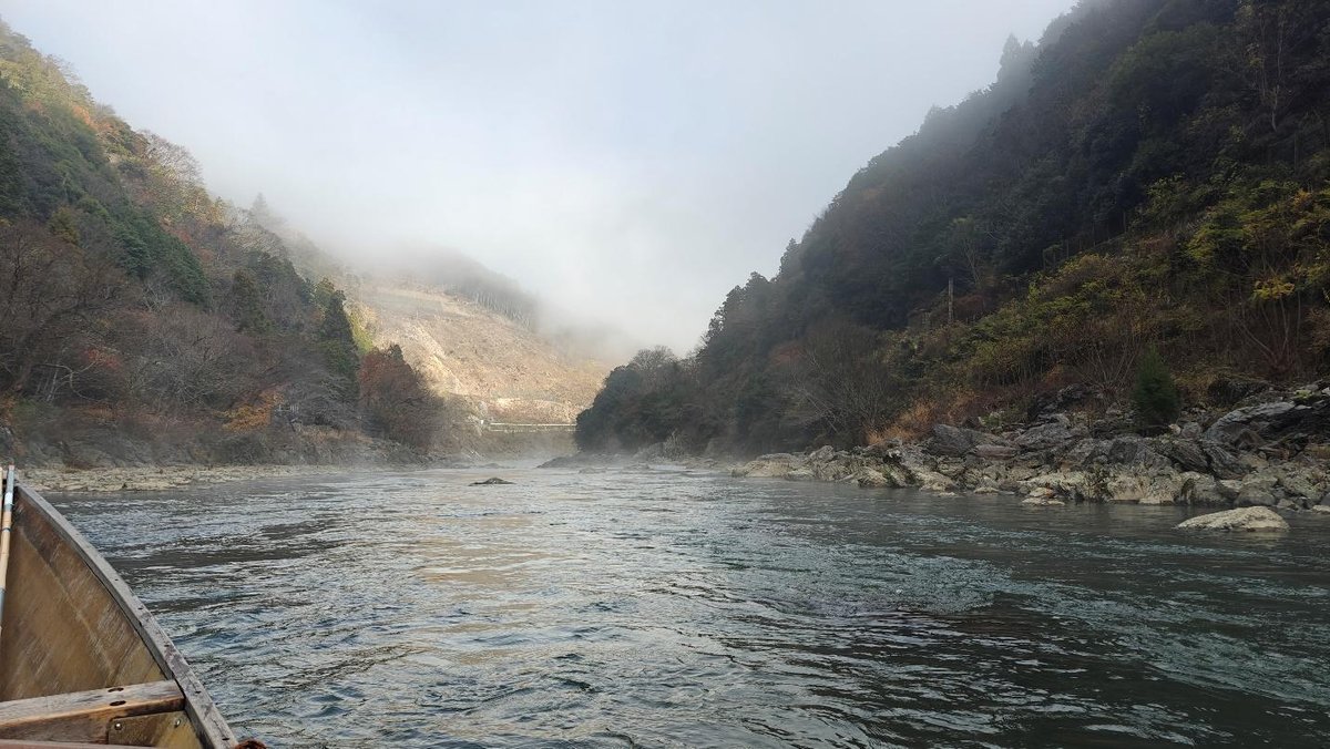 Misty river surrounded by lush green hills