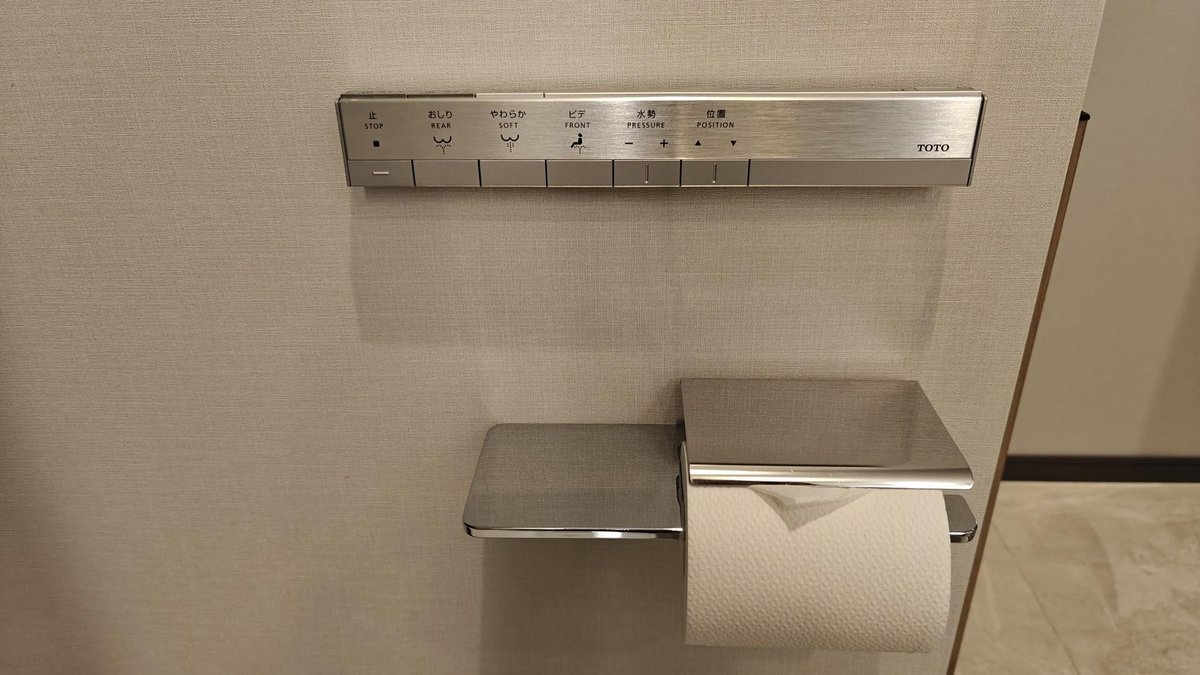 Modern bidet controls on bathroom wall