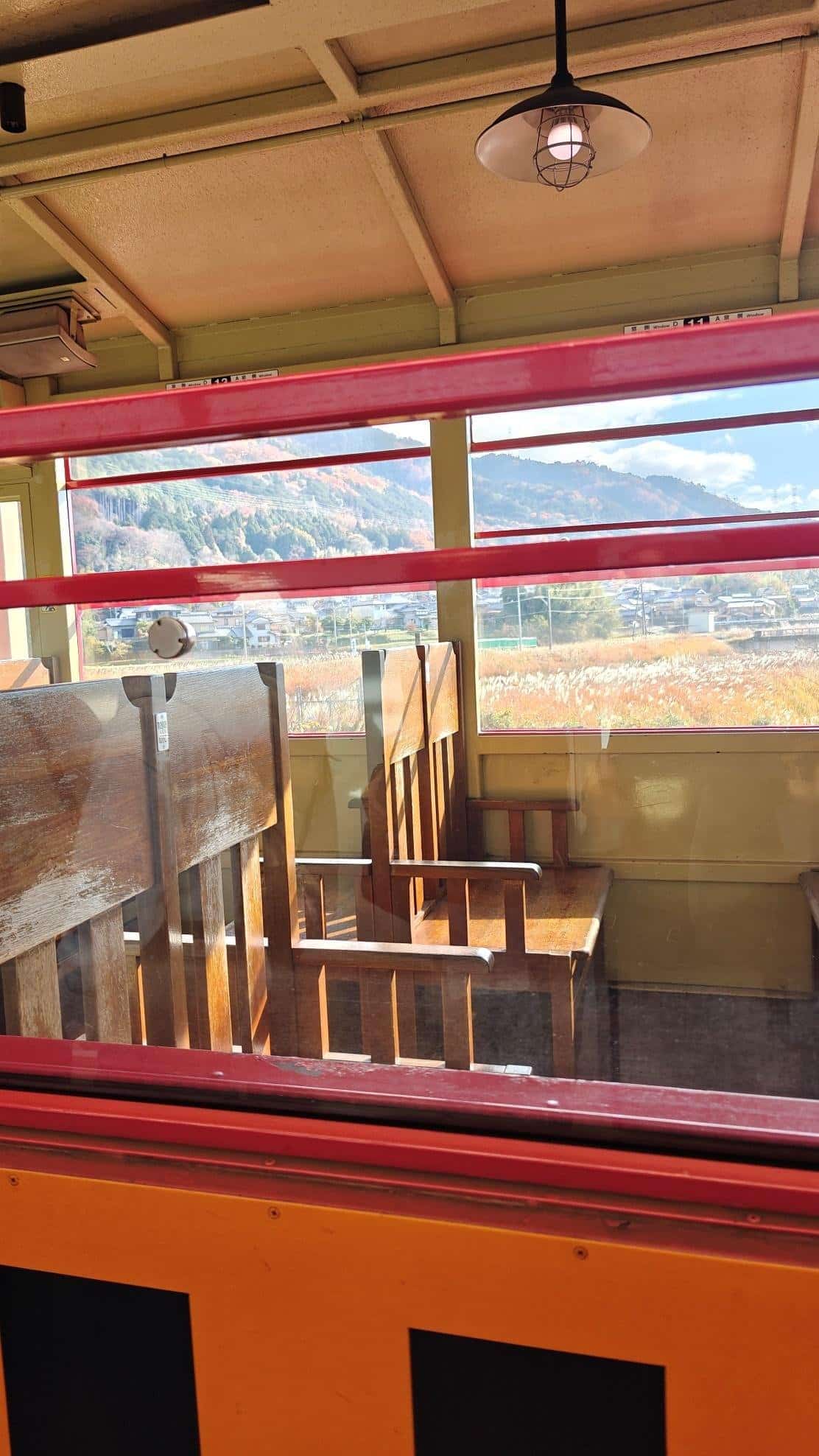 Mountain view from vintage train with wooden seats