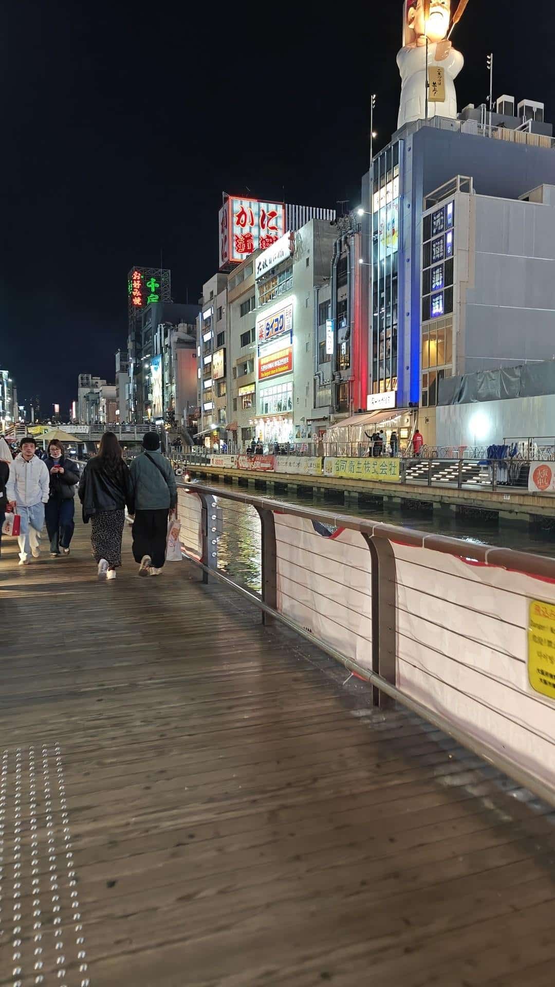 Nighttime city canal walk with lights