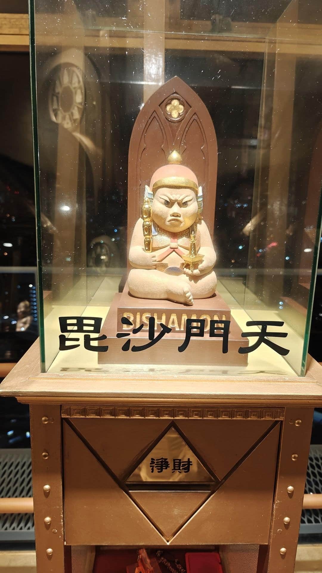 Ornate statue in glass display