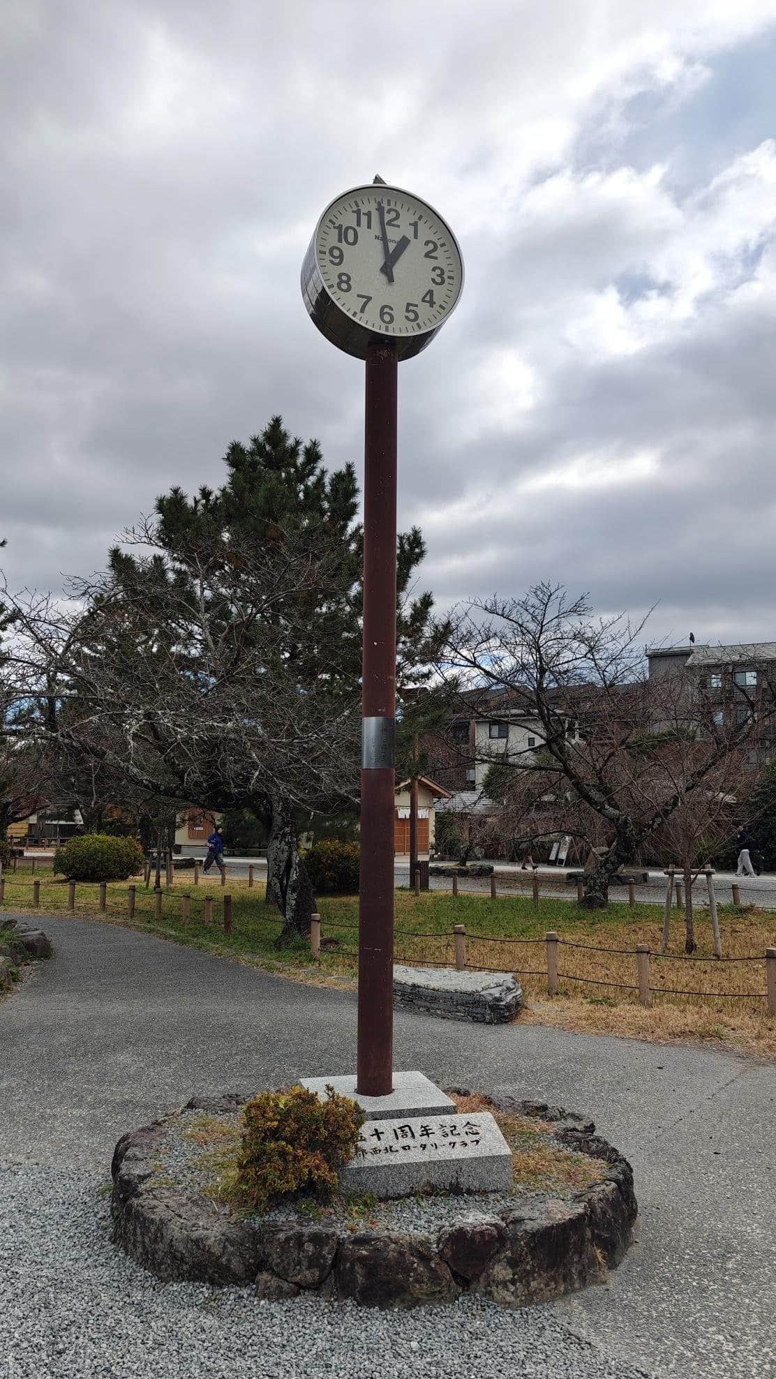Outdoor clock tower with cloudy sky backdrop
