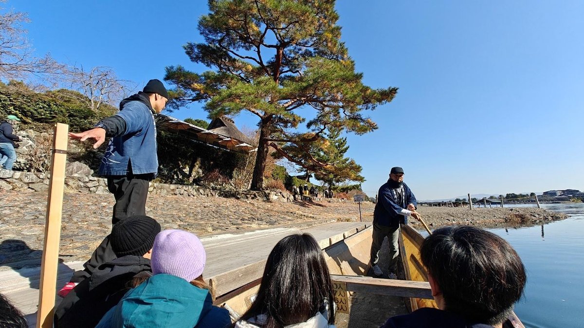 People on a boat ride with scenic riverside view