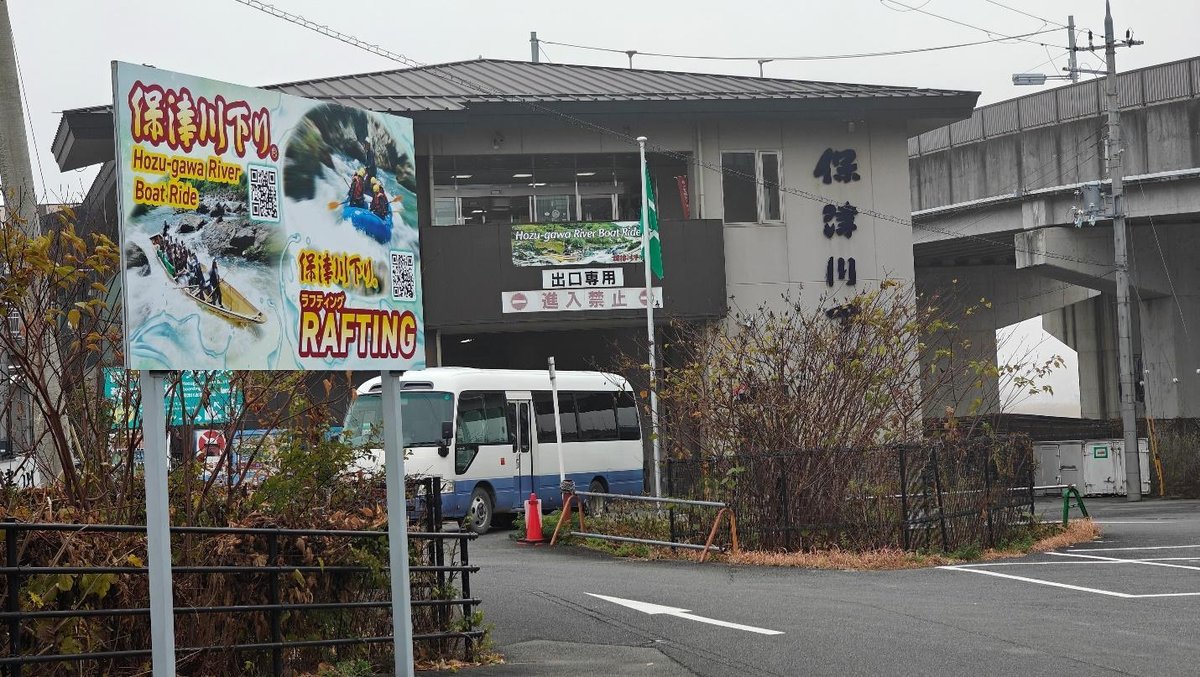 Rafting sign near bus and building entrance