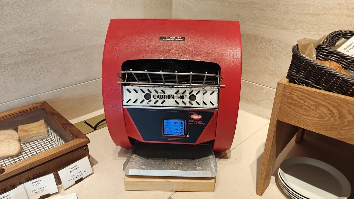 Red conveyor toaster on counter