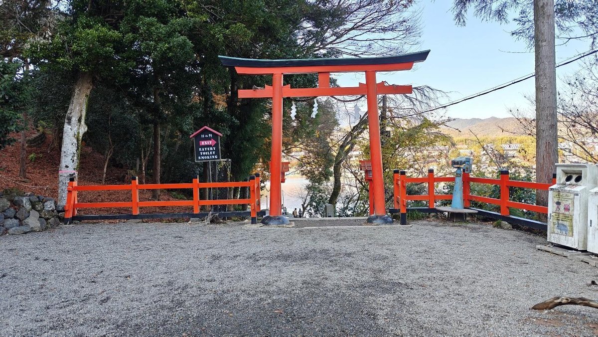 Red torii gate with forest backdrop