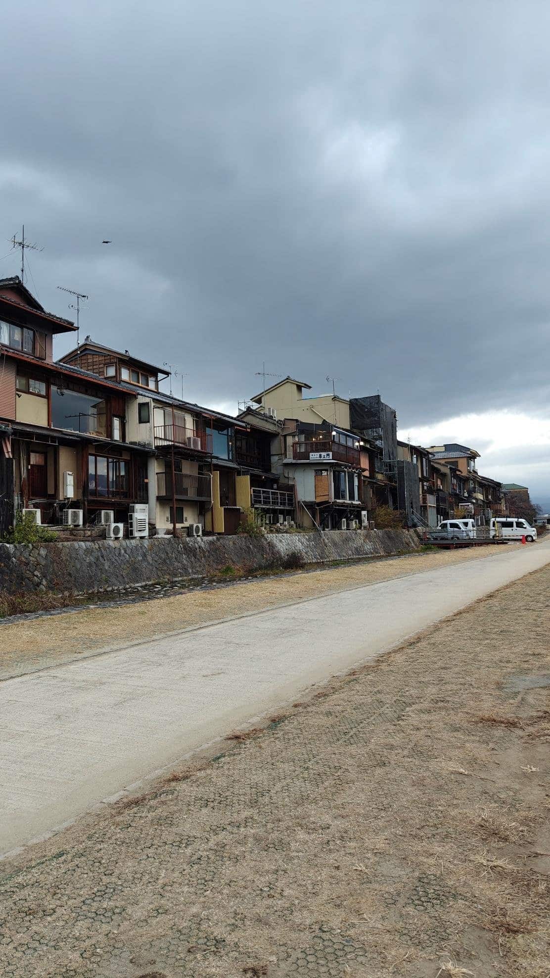 Row of traditional houses under a cloudy sky