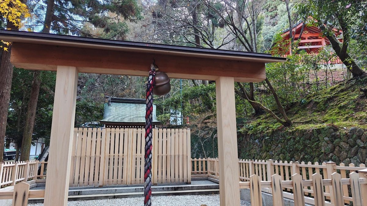 Sacred shrine rope and bell in a wooded temple setting