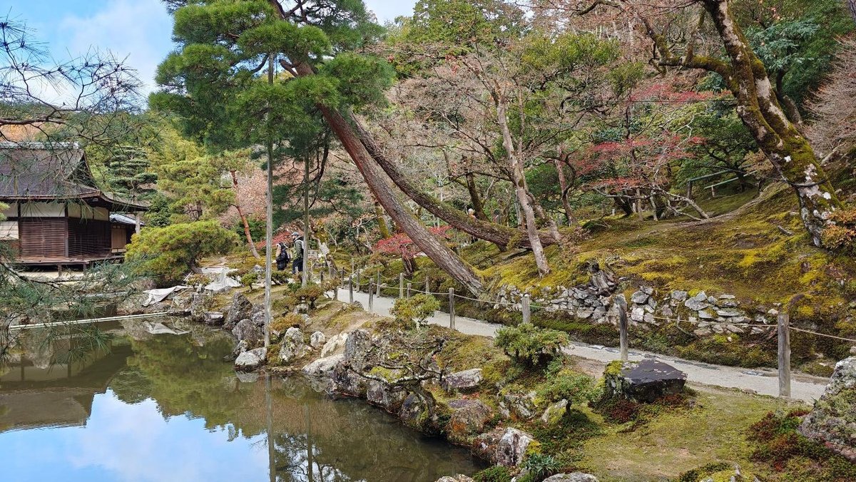 Serene Japanese garden with pond and traditional wooden house