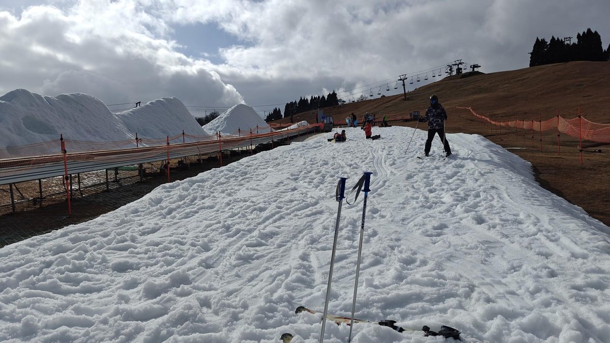 Skiing on snowy slope under cloudy sky