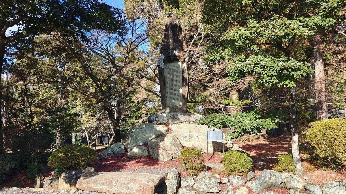 Stone monument surrounded by lush trees and rocks