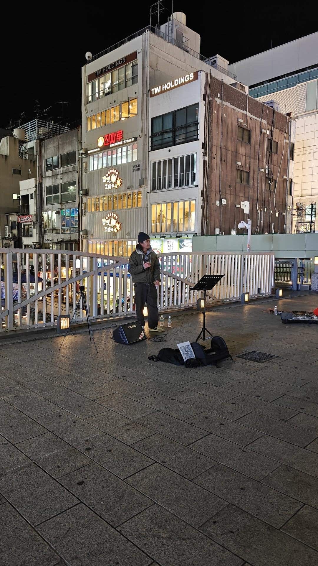 Street performer at night by buildings