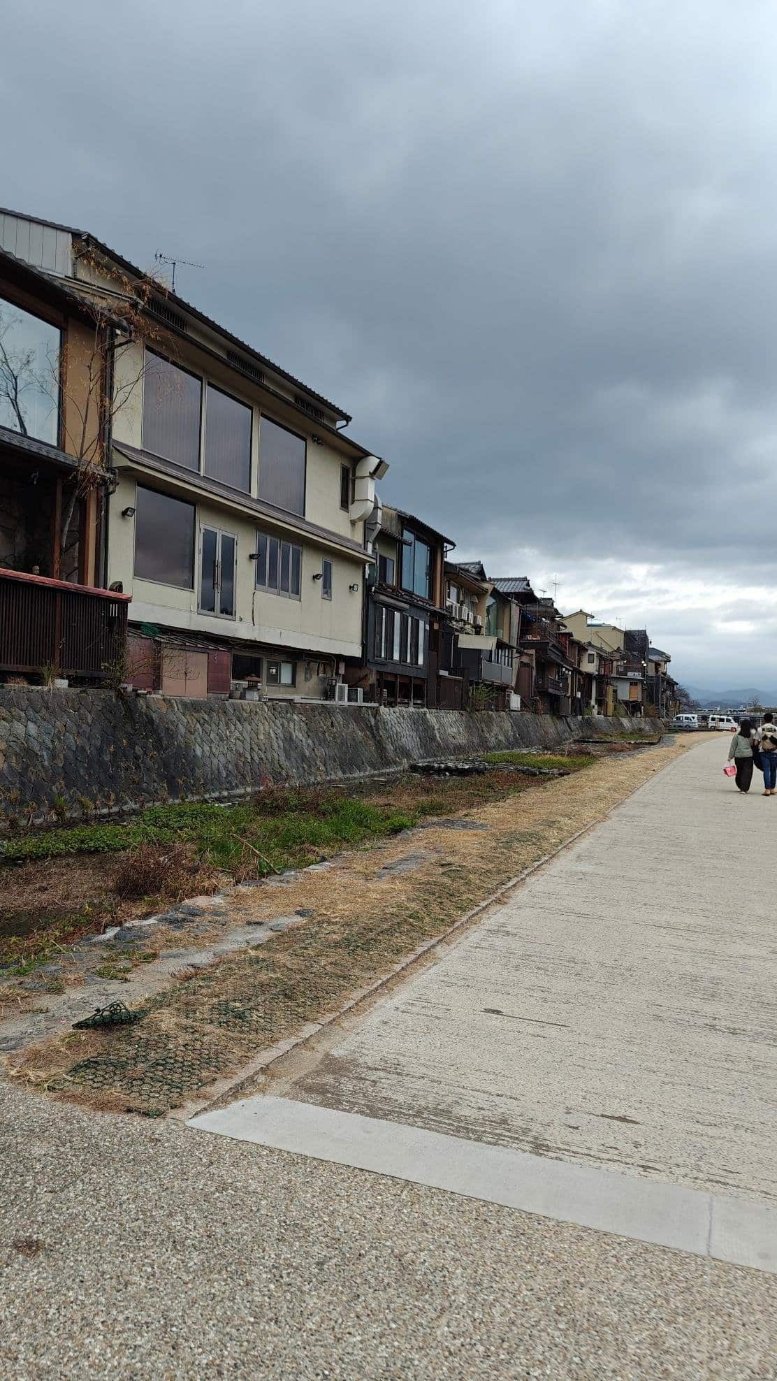 Street with traditional houses under cloudy sky