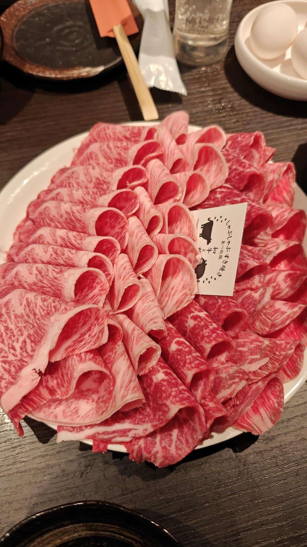 Thinly sliced marbled beef on a plate