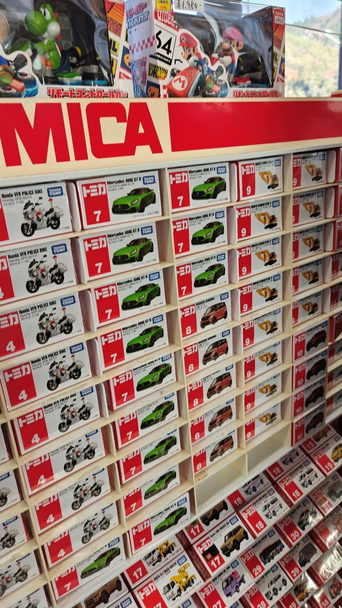 Toy car display with shelves of boxed model cars