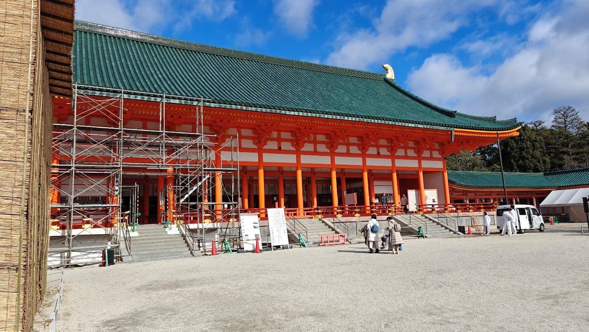 Traditional Asian temple with orange columns and green roof