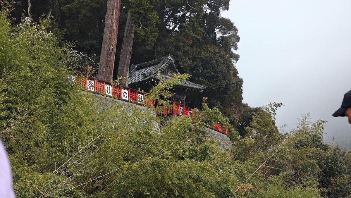 Traditional building with red railing in lush greenery
