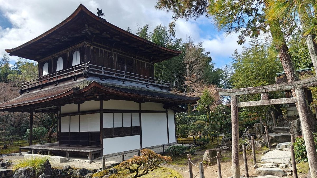Traditional Japanese building with garden and torii gate