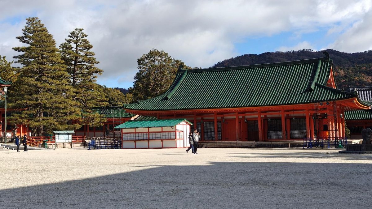 Traditional Japanese building with green roof and trees