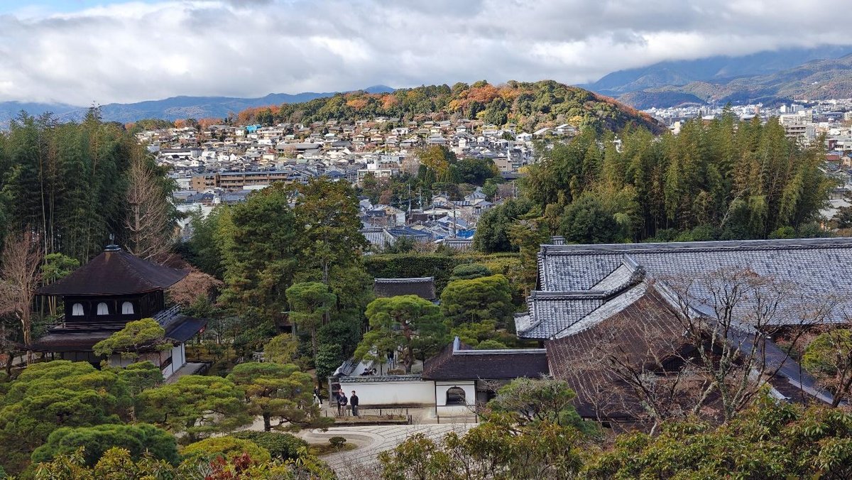 Traditional Japanese garden and cityscape with mountains