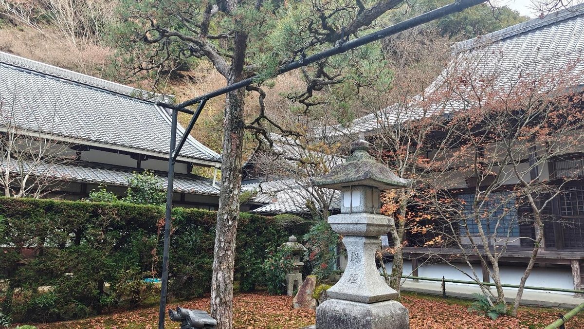 Traditional Japanese garden with stone lantern and autumn trees