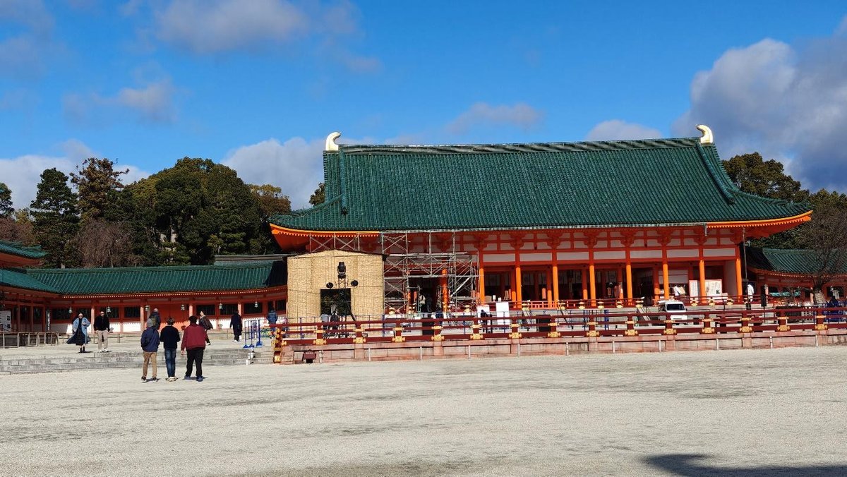 Traditional Japanese temple with green roof under blue sky