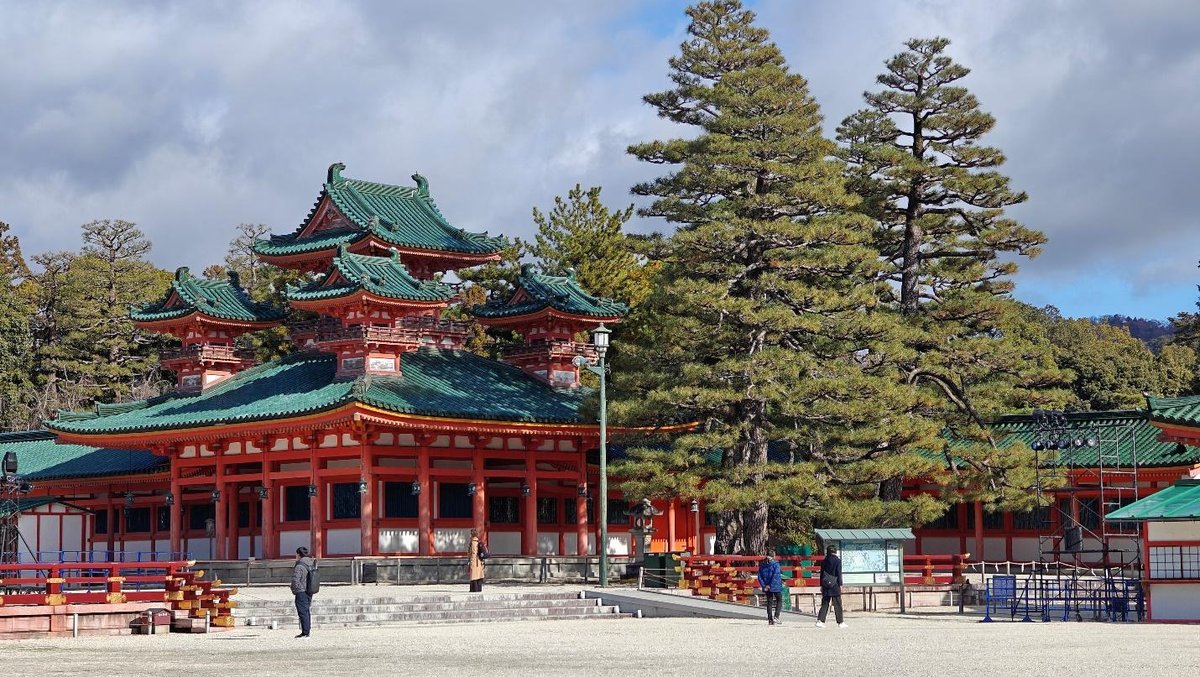 Traditional Japanese temple with green roofs and trees