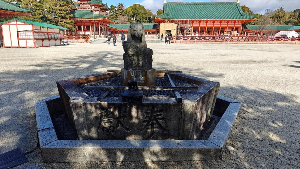 Traditional Japanese temple with stone sculpture in courtyard