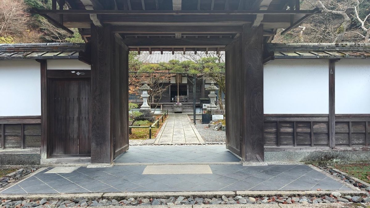Traditional wooden gate leading to a serene garden path