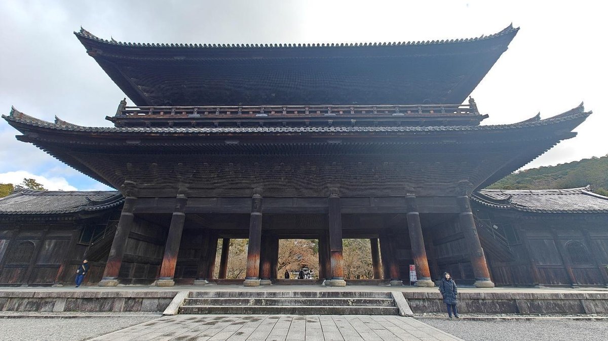 Traditional wooden temple with tiered roof and columns
